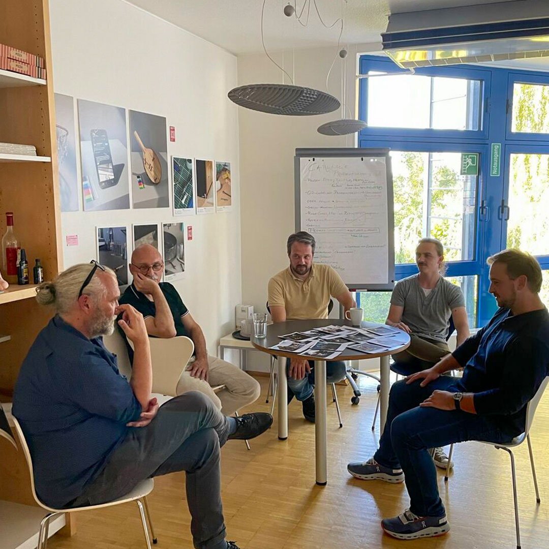 Five men attending a group meeting at wob