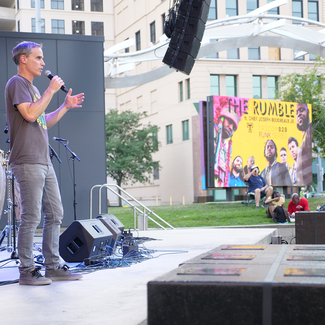 TriComB2B principal, Chris Eifert on stage at the Levitt Pavilion 