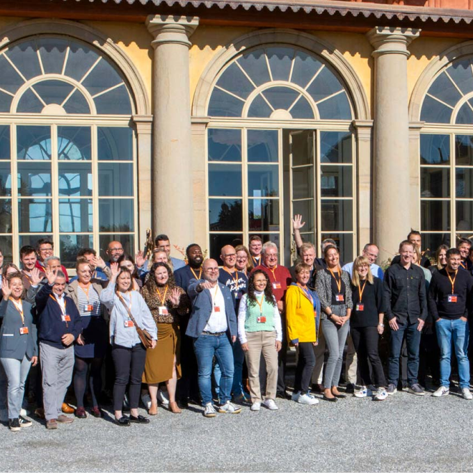 Group of people in front of a windowed building