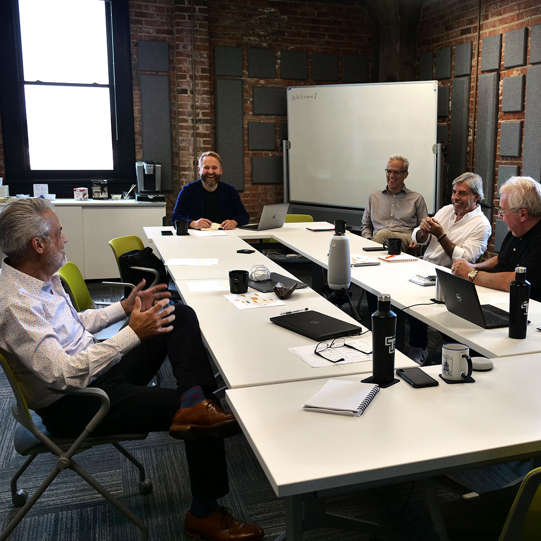 Several men around a large meeting table