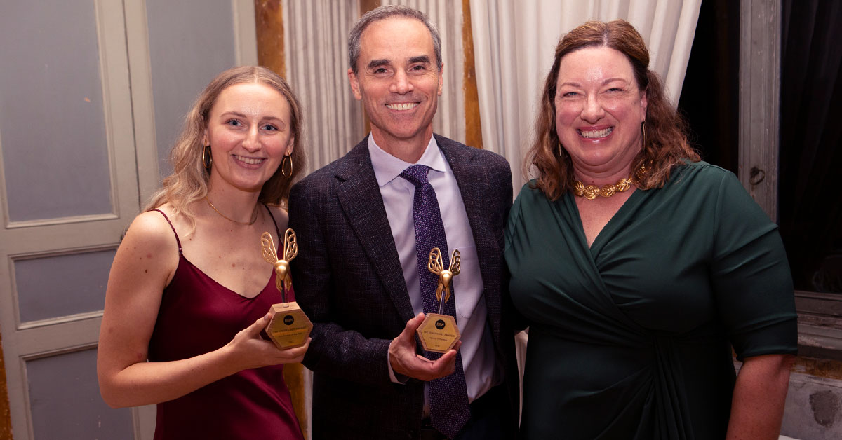 Kaitlyn Kraus, Chris Eifert and Michelle Crawley smiling with two BBN Golden Bee awards